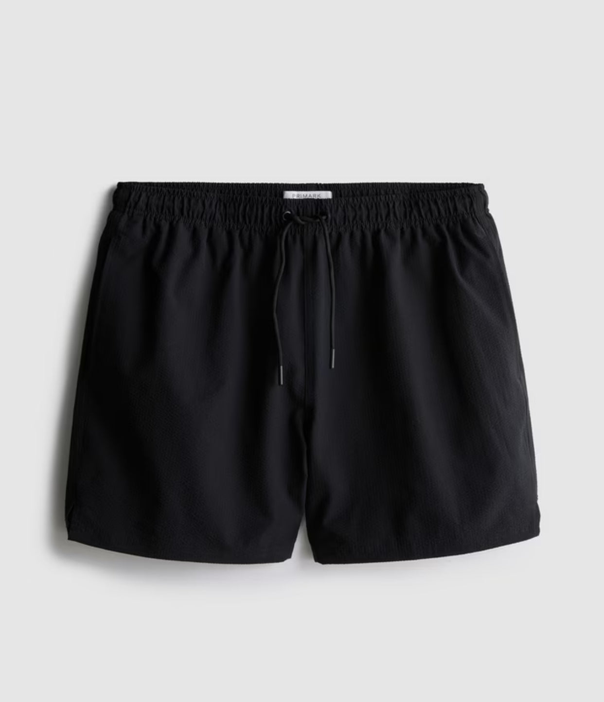 A pair of textured swimming shorts with a drawstring waistline