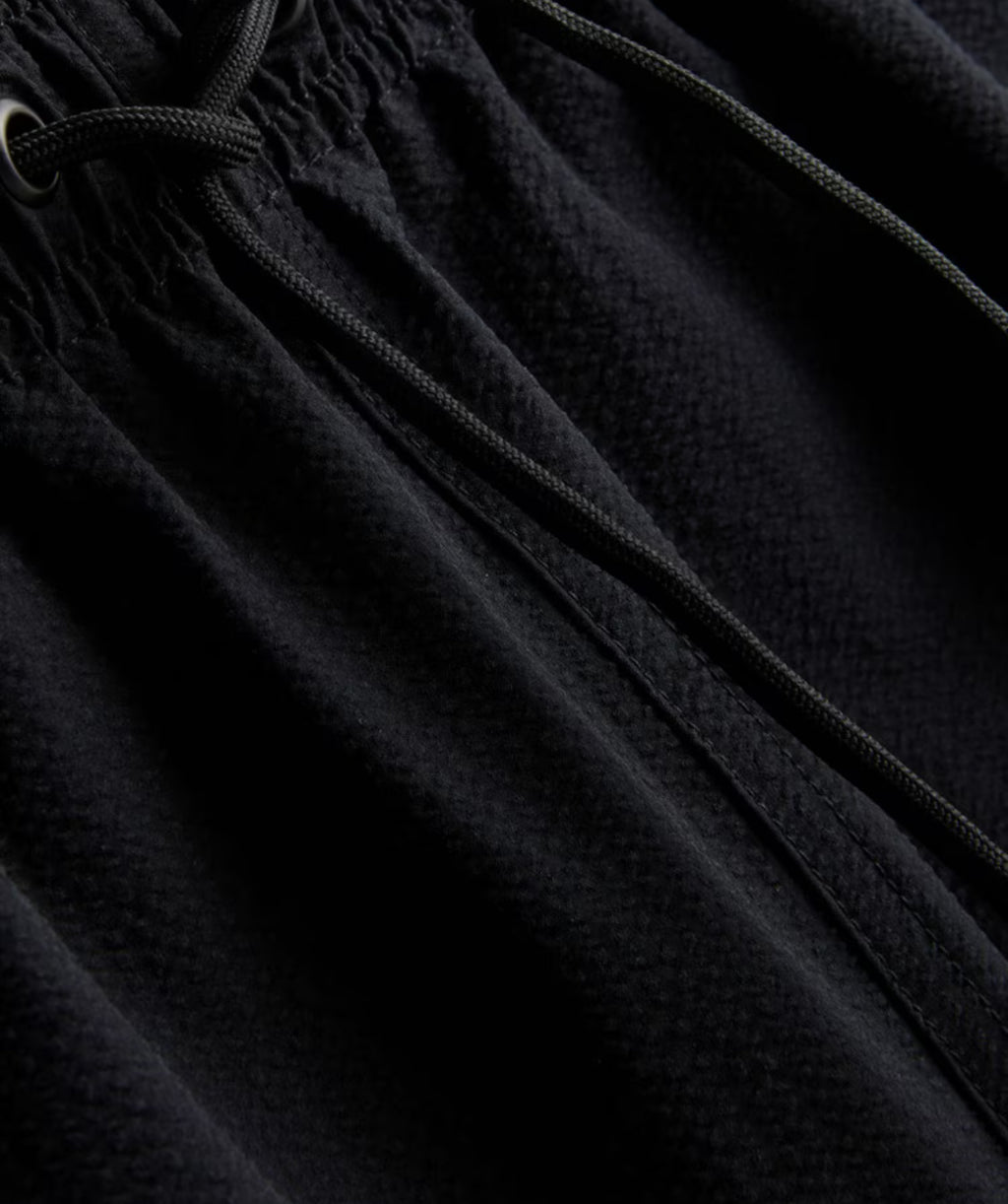 A pair of textured swimming shorts with a drawstring waistline
