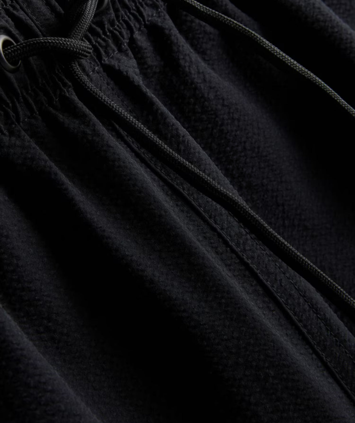 A pair of textured swimming shorts with a drawstring waistline