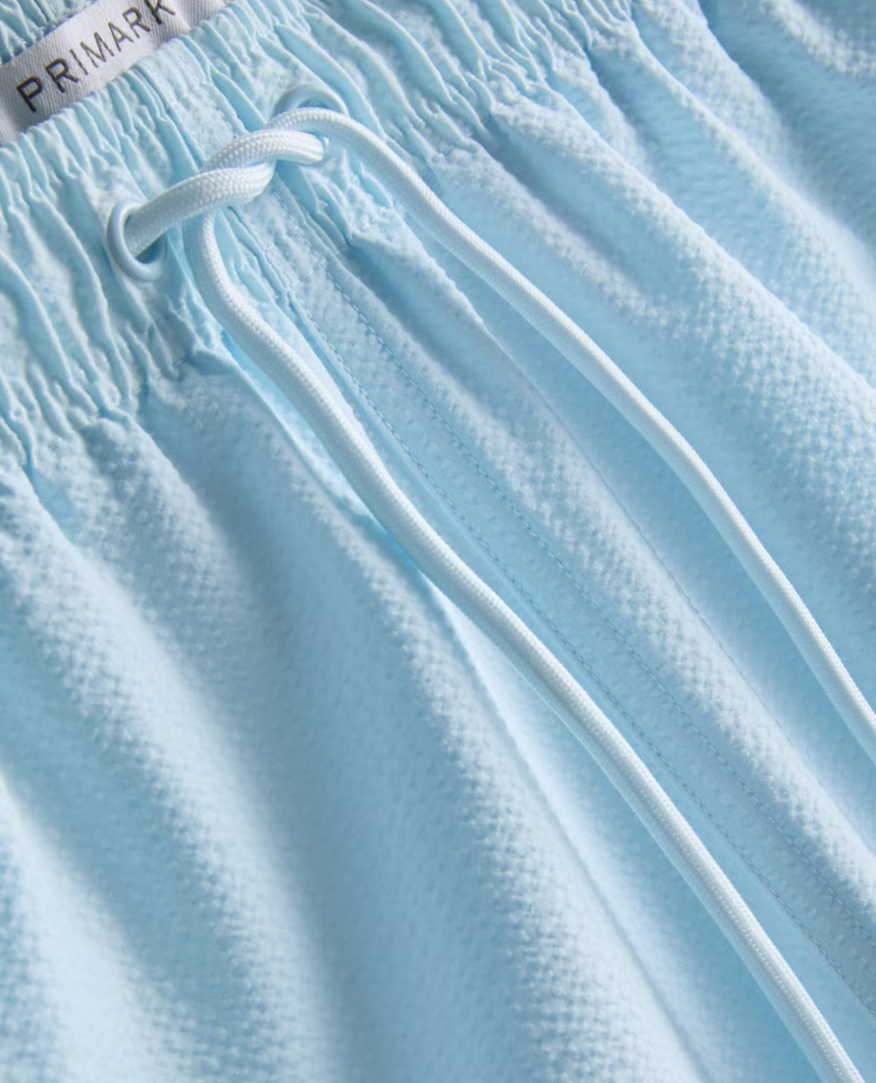 A pair of textured swimming shorts with a drawstring waistline
