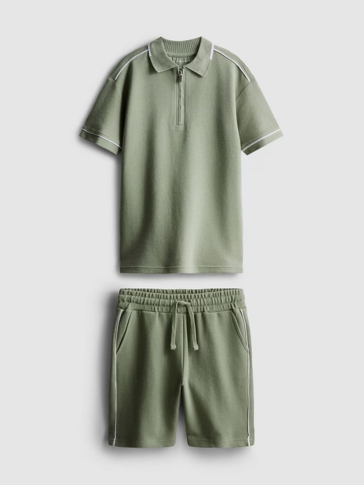 A polo shirt and shorts clothing co-ord in a textured