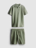 A polo shirt and shorts clothing co-ord in a textured