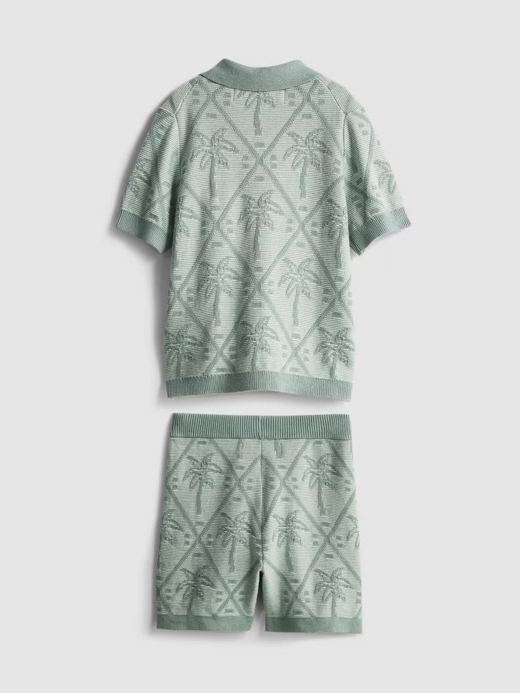 A knitted shirt and shorts clothing co-ord with a palm tree design