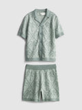 A knitted shirt and shorts clothing co-ord with a palm tree design