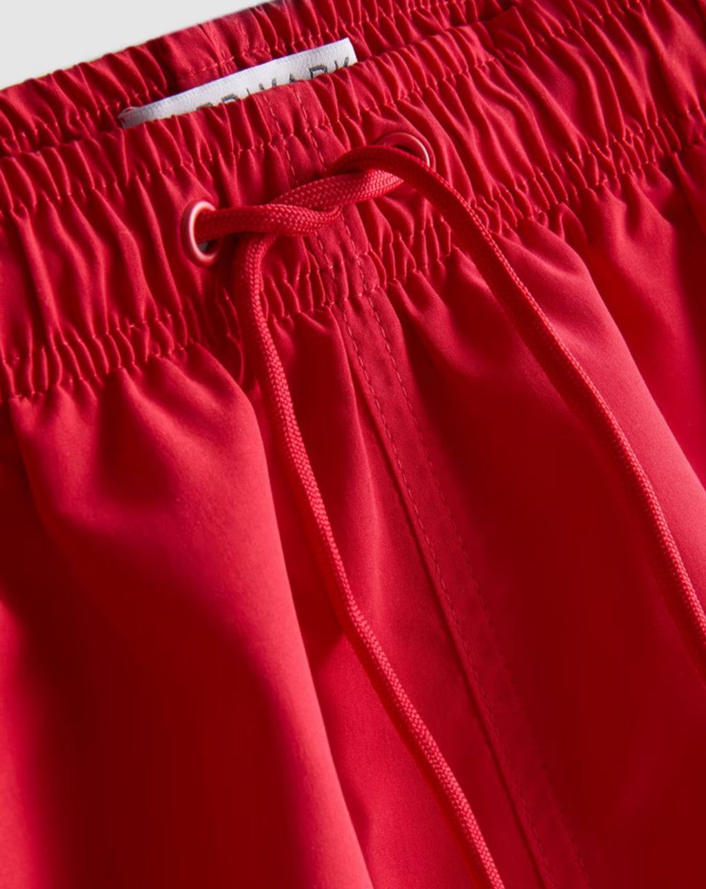 A pair of microfibre swimming shorts with drawstring waistline, and inner mesh