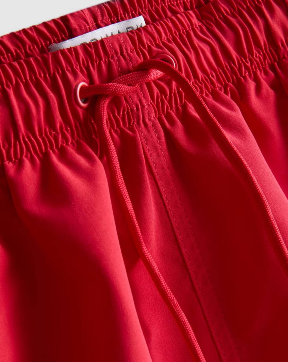 A pair of microfibre swimming shorts with drawstring waistline, and inner mesh