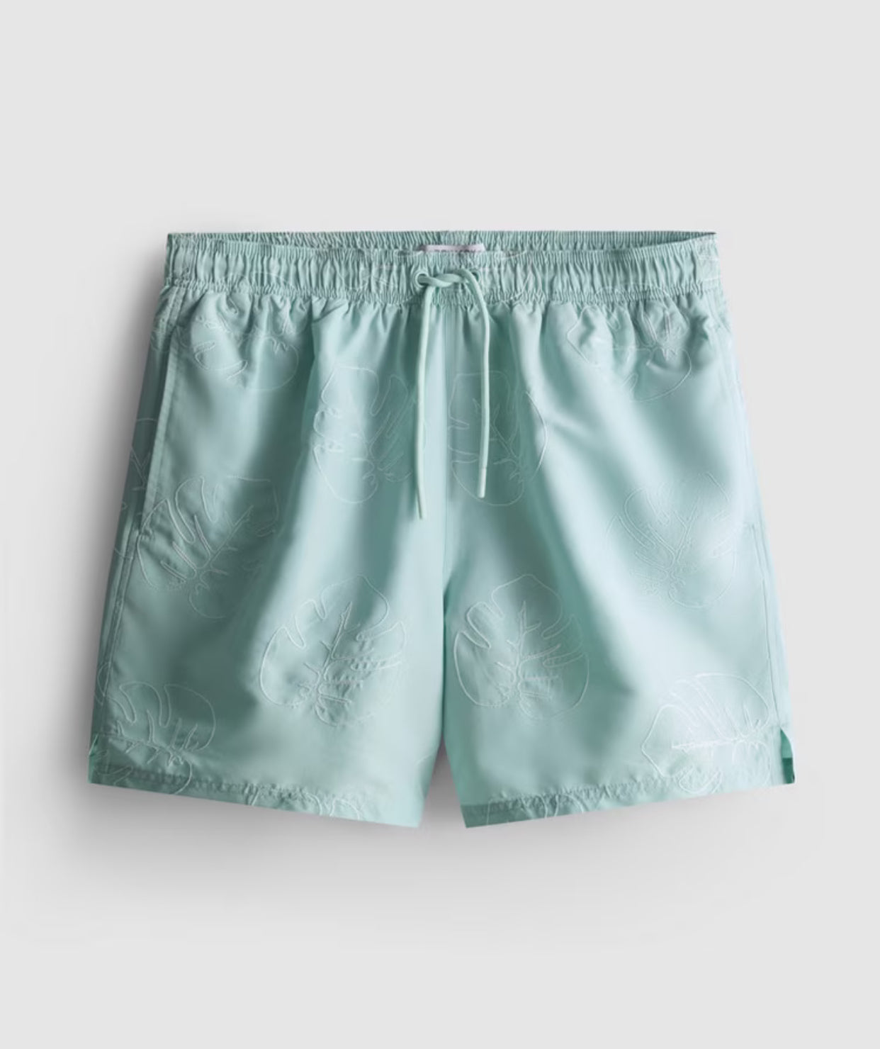 A pair of swimming shorts with an embroidered design, a drawstring waistline, and an inner mesh lining