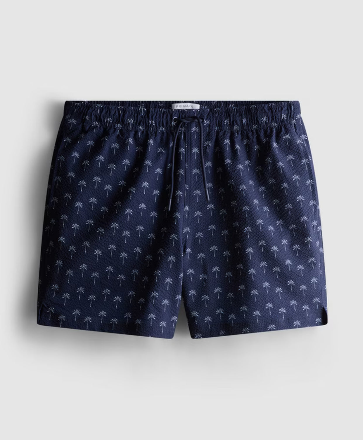 A pair of swimming shorts with palm tree design
