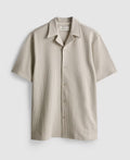 A button-up pyjama top with short sleeves, collar, and ribbed texture