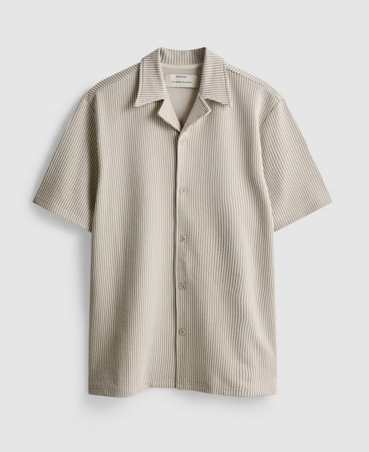A button-up pyjama top with short sleeves, collar, and ribbed texture