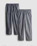 Two pairs of pyjama bottoms with a drawstring waistline and a poplin texture