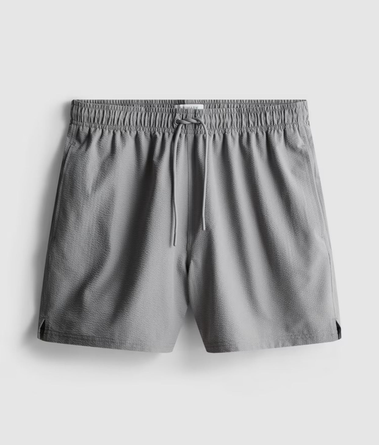 A pair of textured swimming shorts with a drawstring waistline