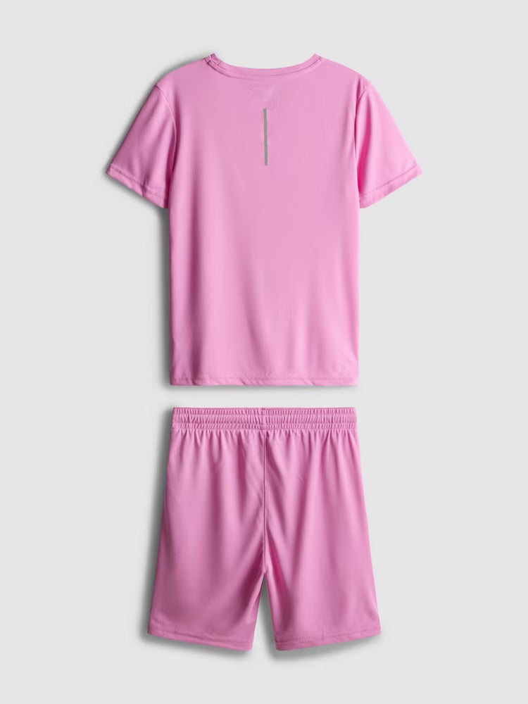 This sporty clothing set includes a short sleeve top and drawstring-detail shorts