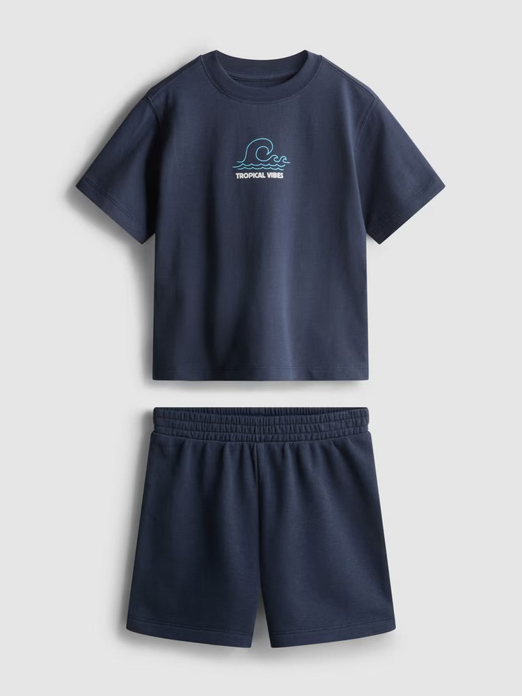 A flocked tee and shorts co-ord with a tropical graphic desian