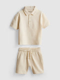 A textured polo shirt and shorts clothing co-ord