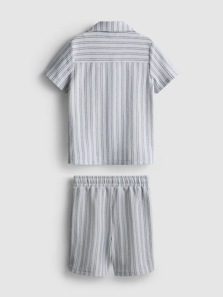 A knitted shirt and shorts co-ord in a stripe pattern