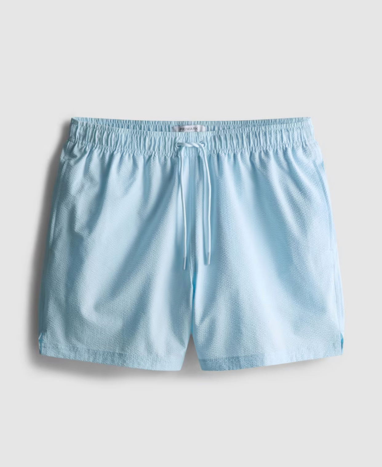 A pair of textured swimming shorts with a drawstring waistline