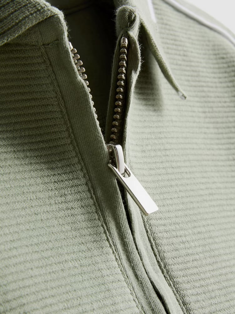 A polo shirt and shorts clothing co-ord in a textured