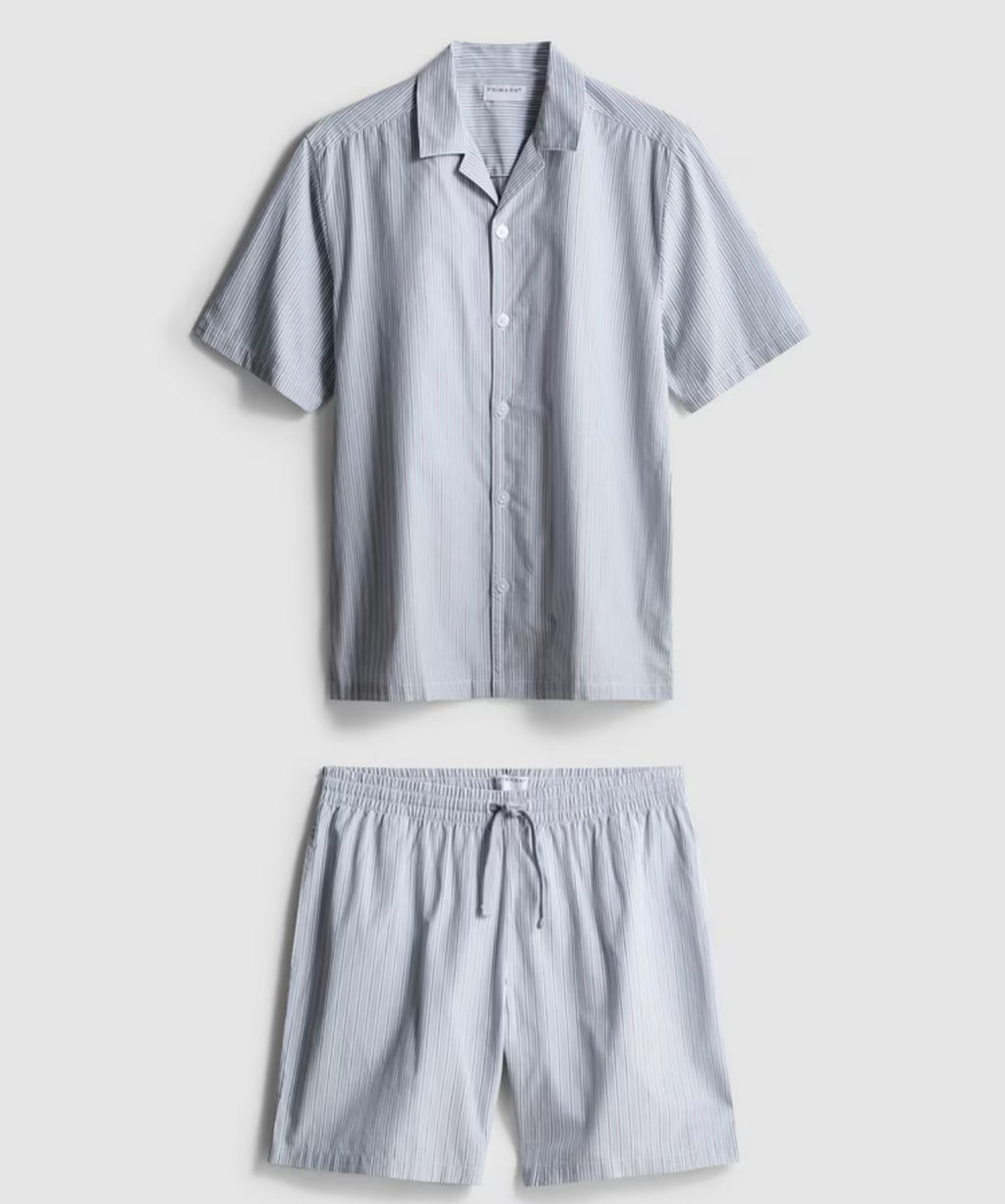 A pair of pyjamas with shorts and button up top