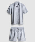 A pair of pyjamas with shorts and button up top