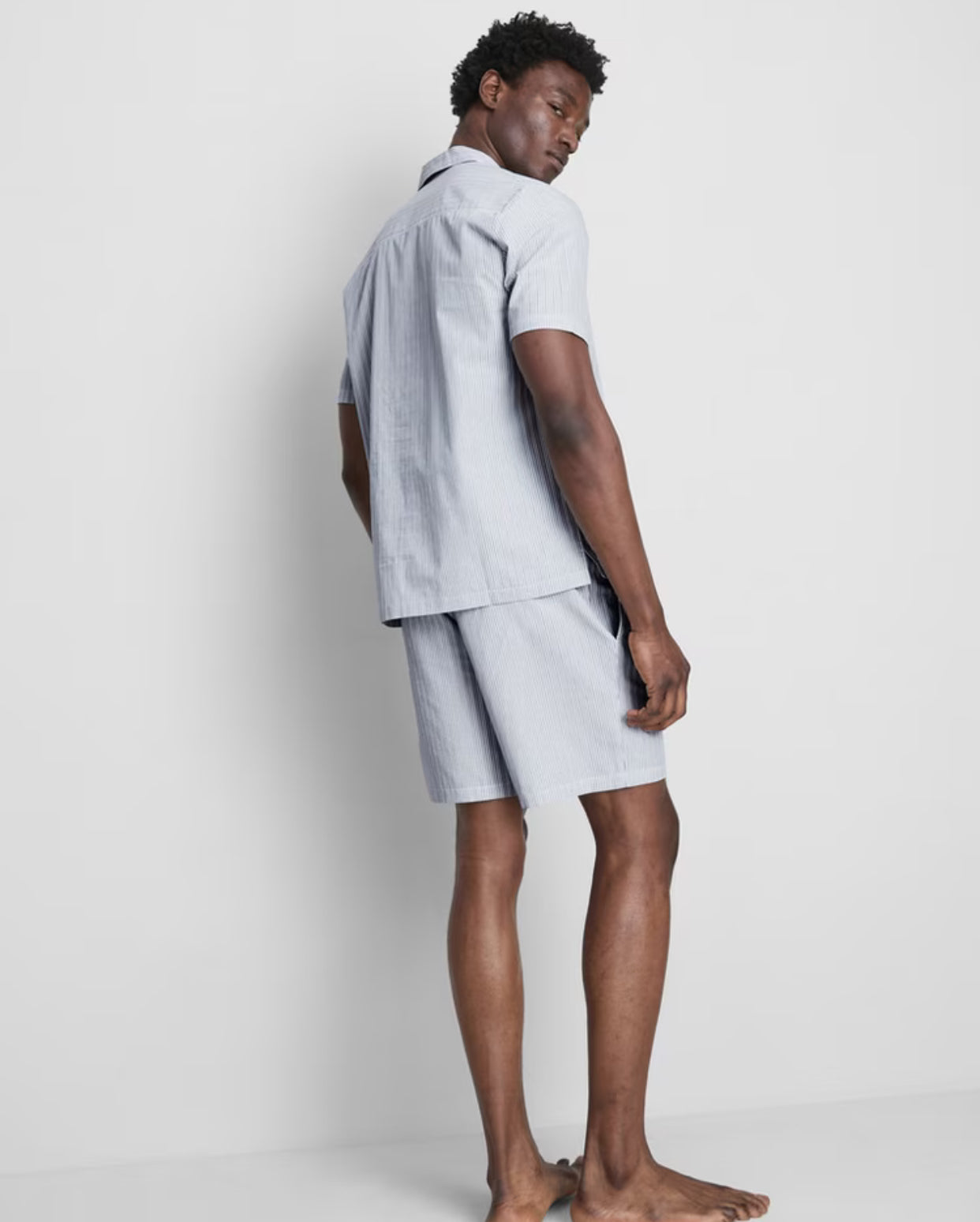 A pair of pyjamas with shorts and button up top