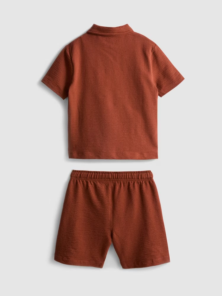 A textured polo shirt and shorts clothing co-ord